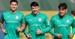 Três homens em uniformes verdes do Palmeiras durante treino ao ar livre