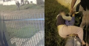 Um jovem segura um homem no chão enquanto outro observa perto de um muro com arame farpado